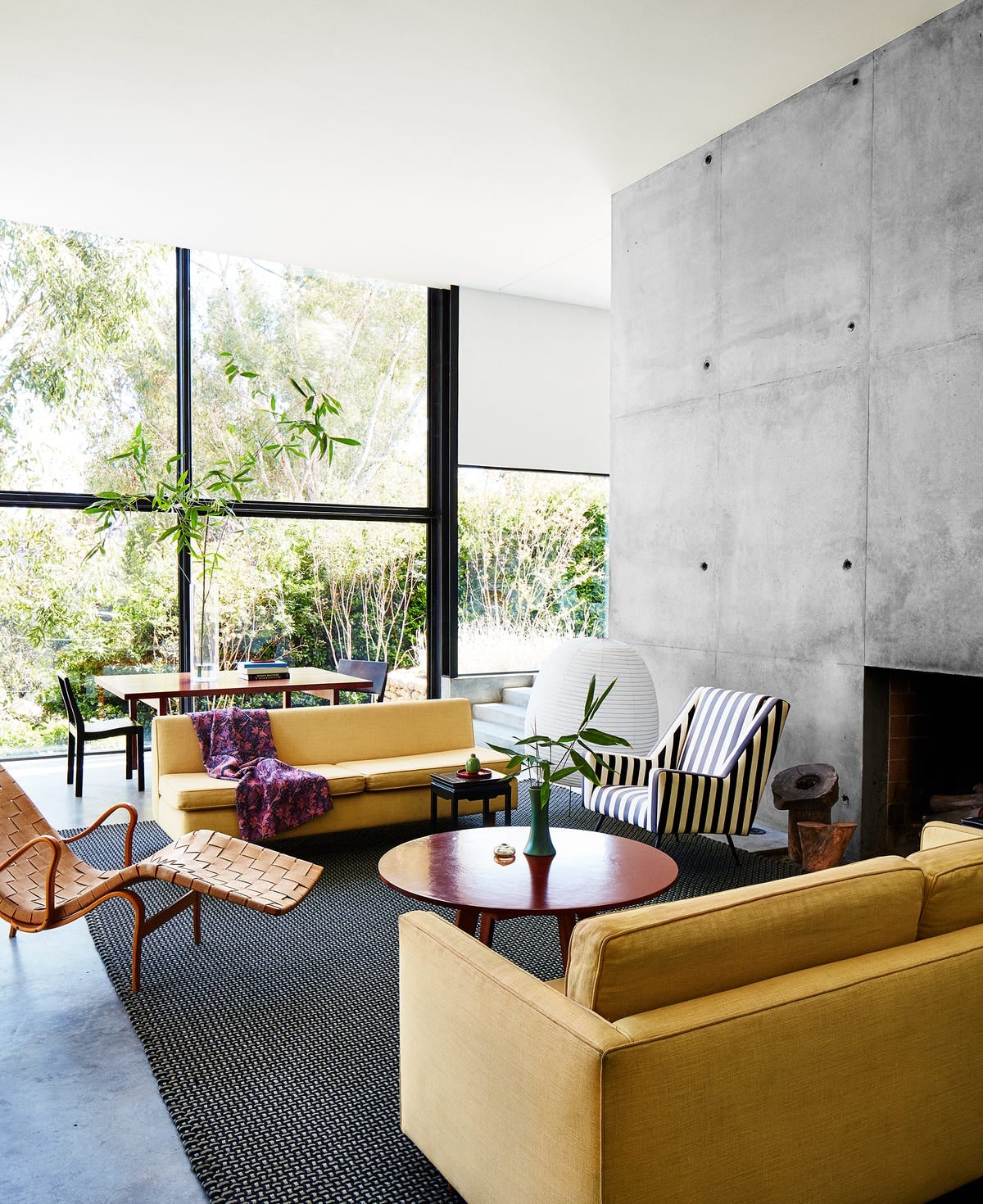 Neo-industrial living room with concrete walls and steel windows. Photo: House Beautiful