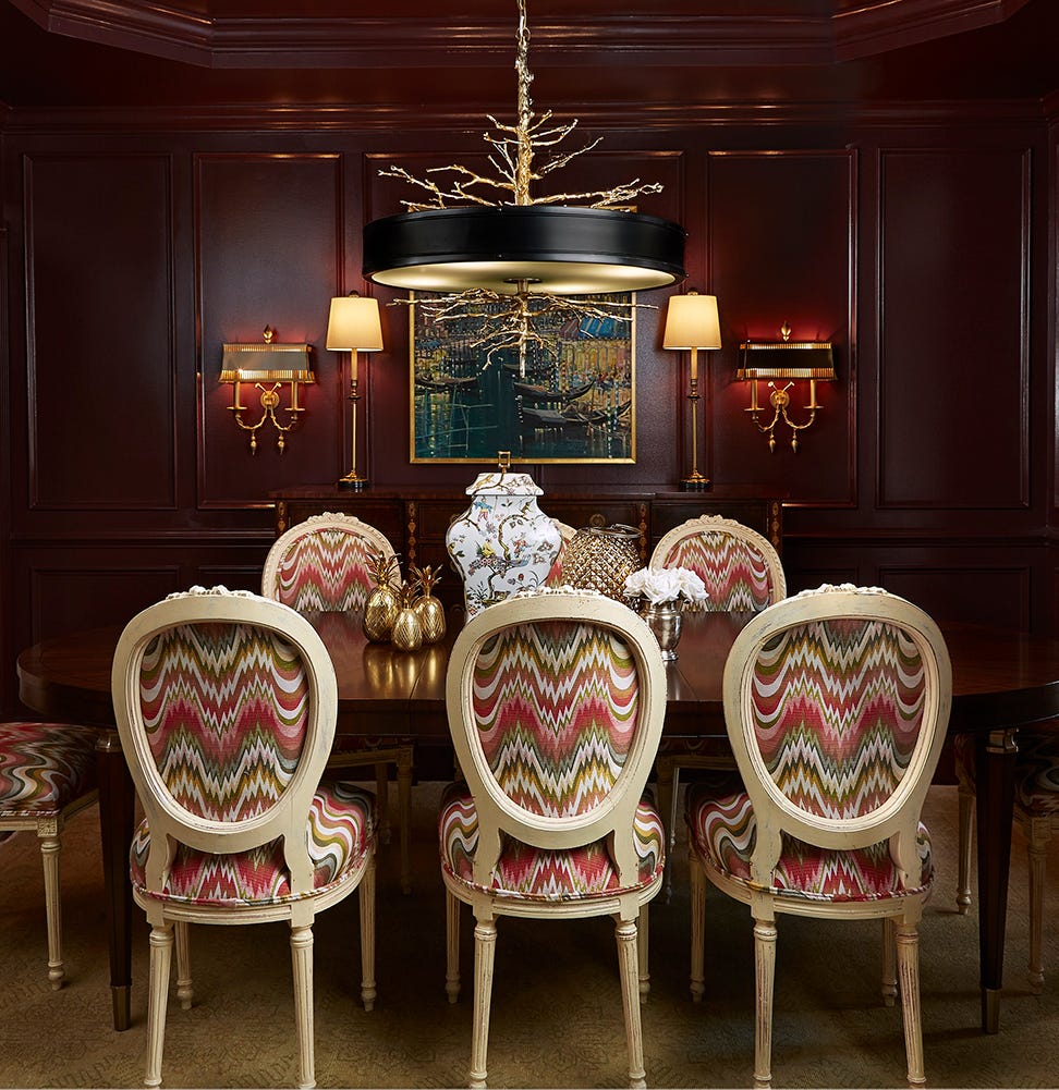 Traditional dining room with mahogany paneling and Louis XVI chairs. Photo: House Beautiful