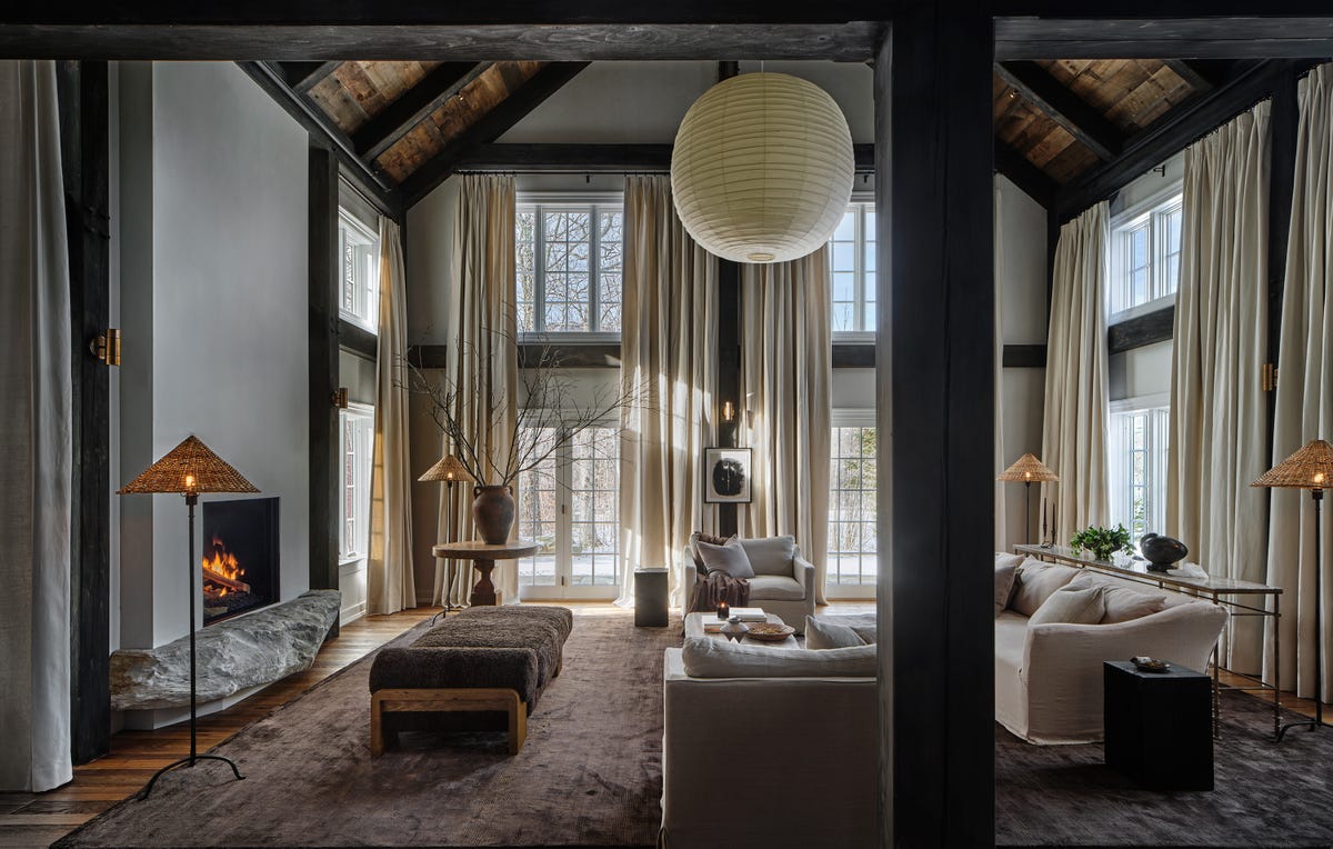 Alpine chic living room with layered wood, stone, and wool textures. Photo: House Beautiful