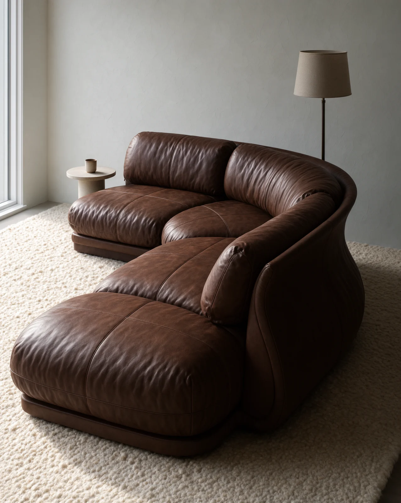The same sofa as a photoreal brown leather piece in a styled room