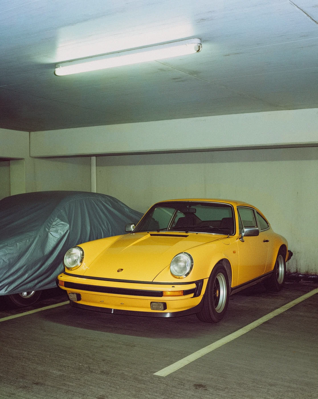 Yellow sports car in an underground parking garage