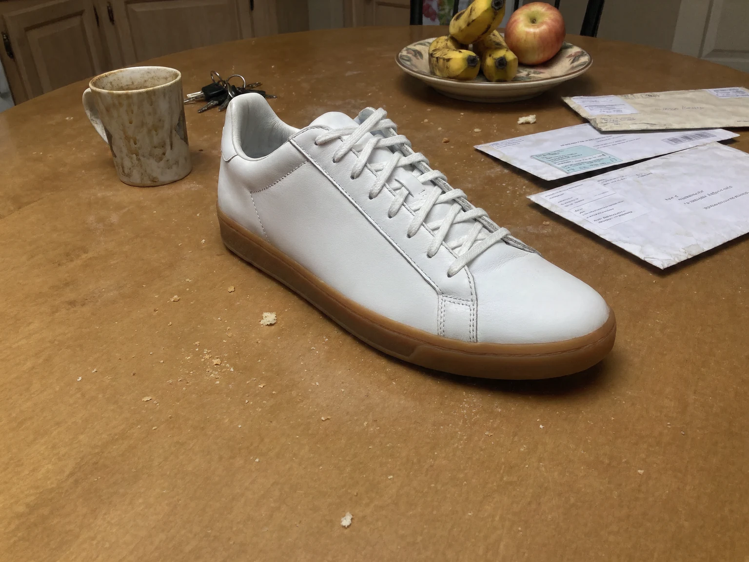 Before: Sneaker on a kitchen table moved to a studio sweep