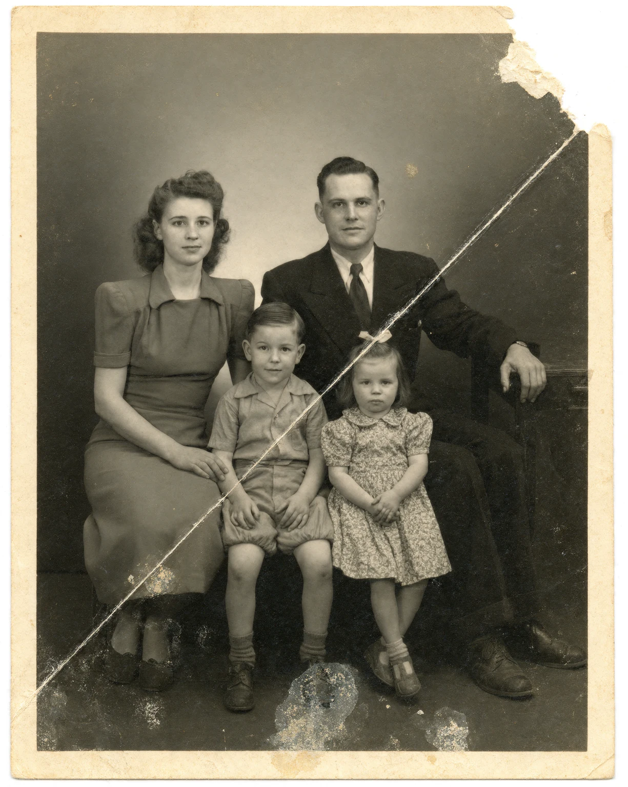 Before: Torn 1940s family portrait restored by AI