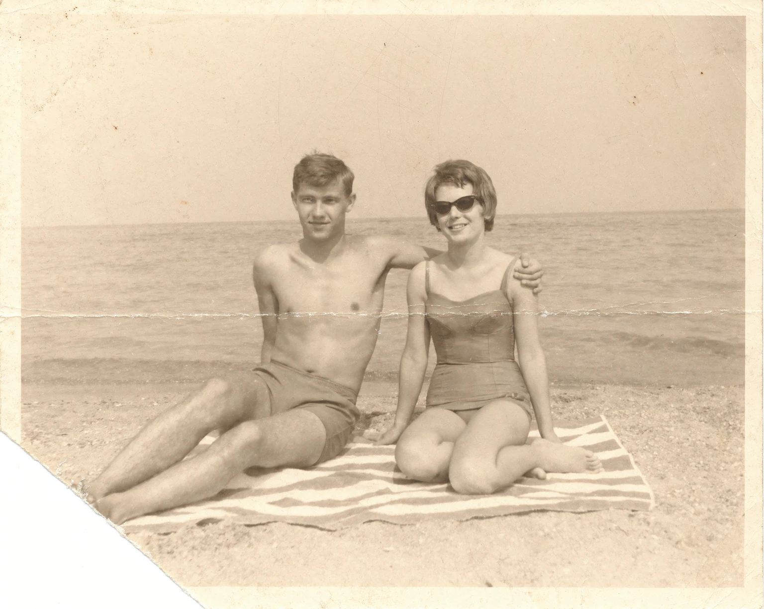 Before: Faded 1960s sepia beach couple photo restored by AI