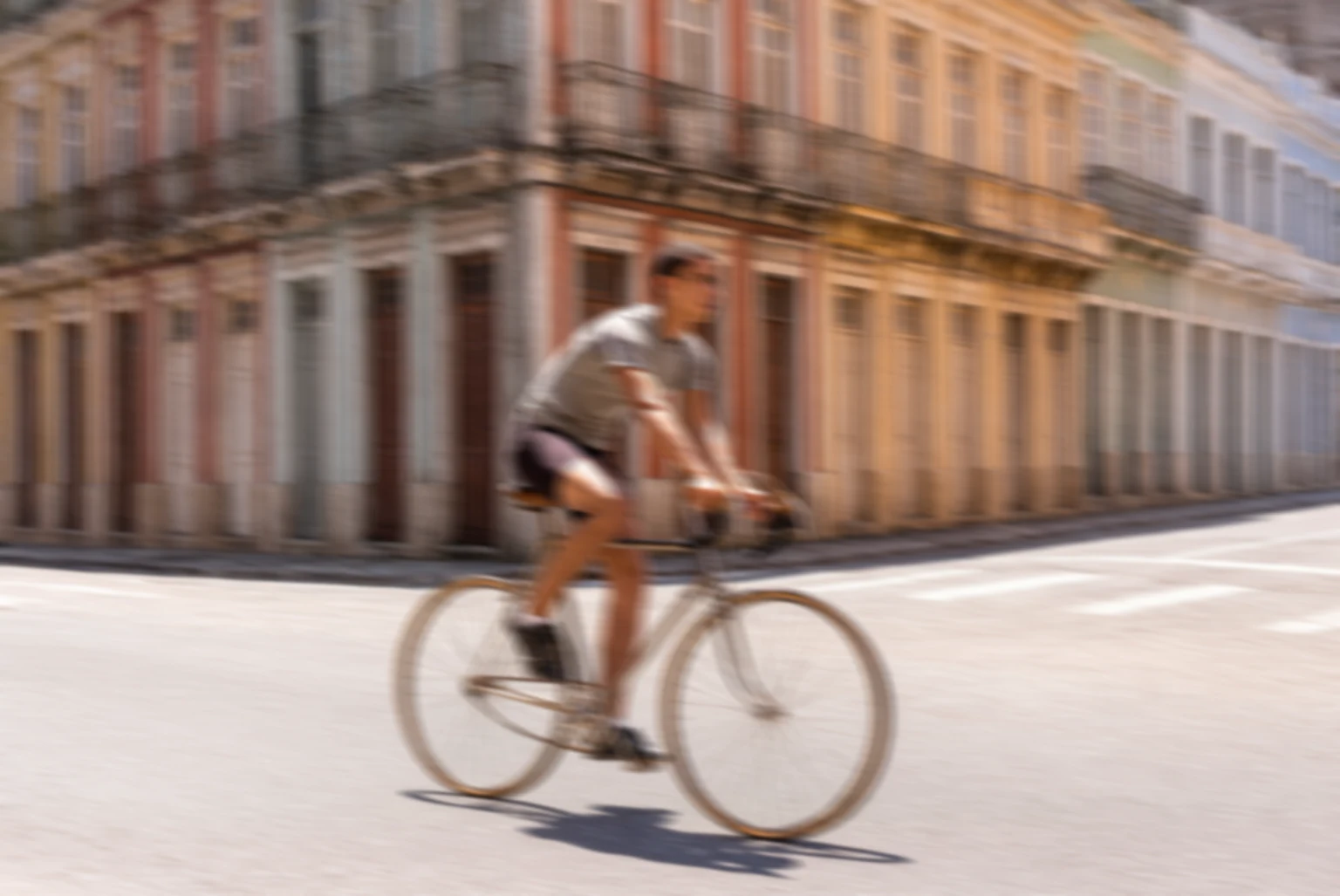 Before: Motion-blurred cyclist on a city street sharpened by AI